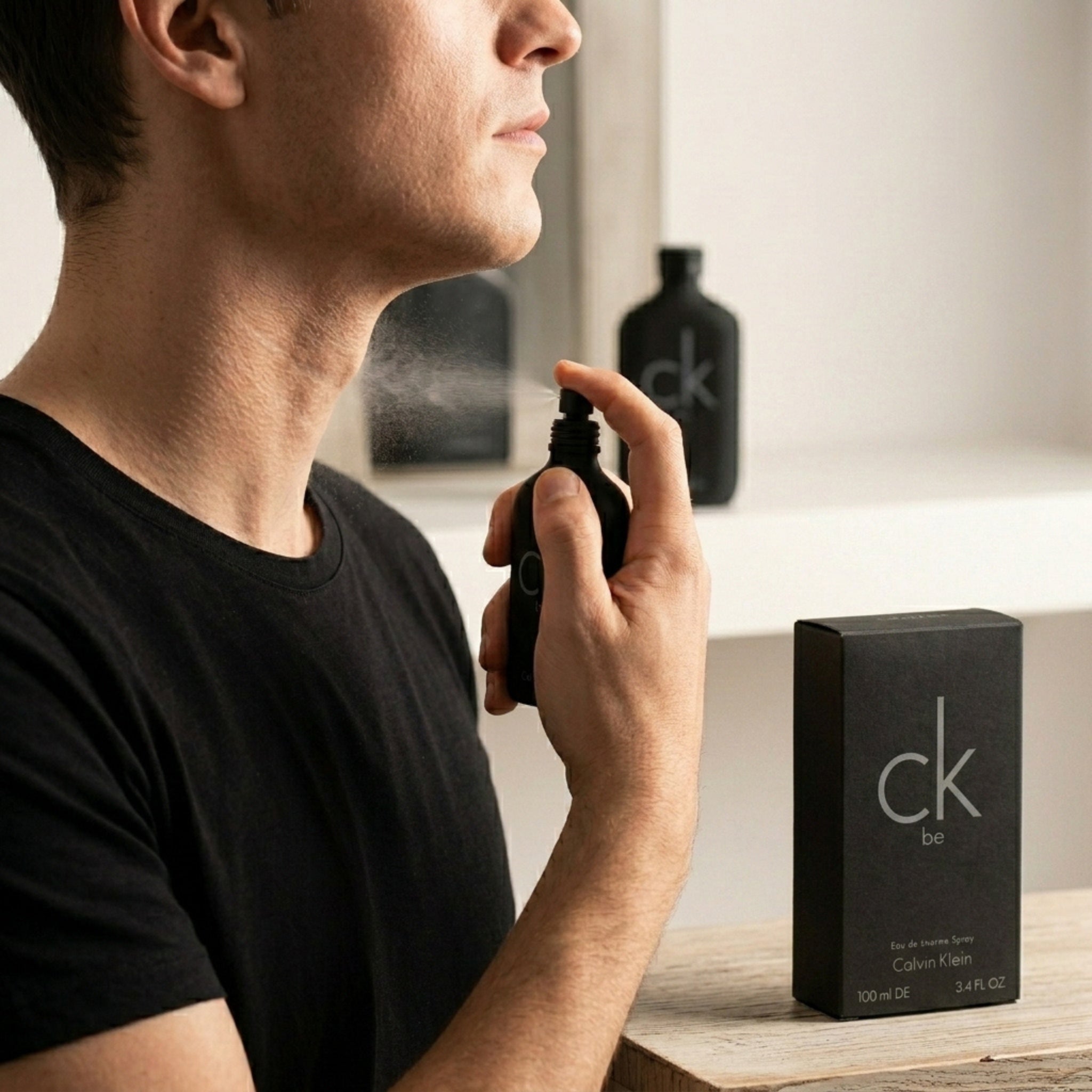 Applying Calvin Klein CK Be perfume on neck pulse point for long lasting fragrance