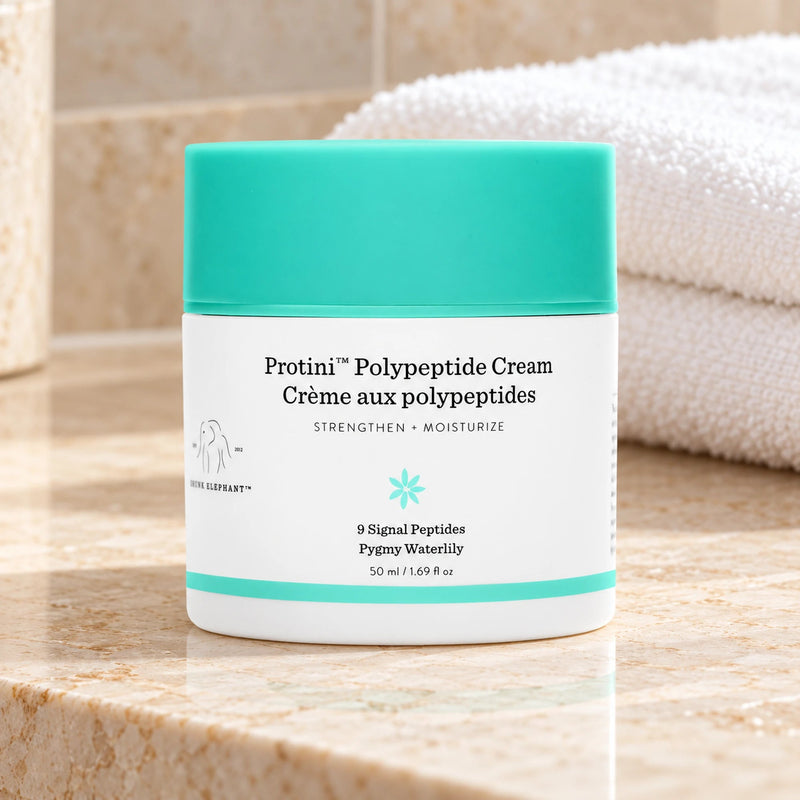 Drunk Elephant Protini cream 50ml jar on a cream bathroom counter