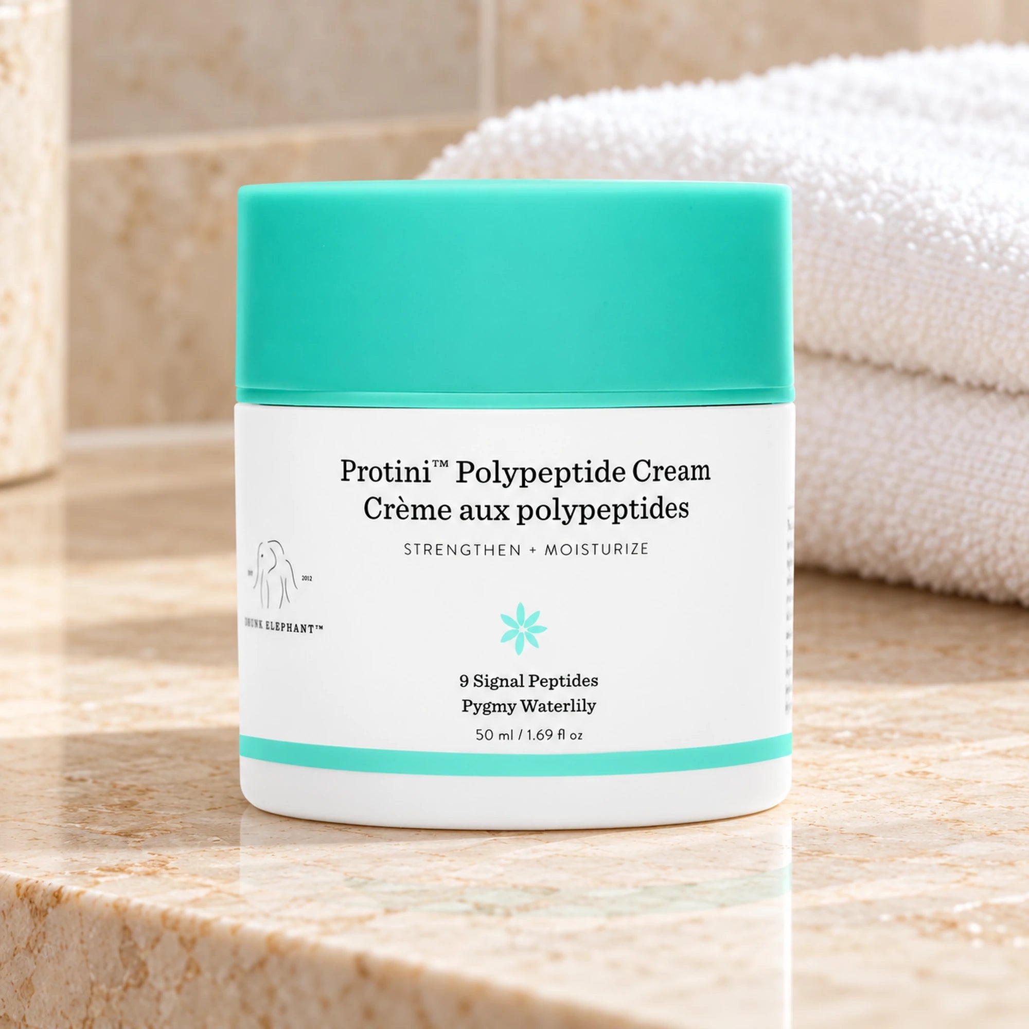 Drunk Elephant Protini cream 50ml jar on a cream bathroom counter